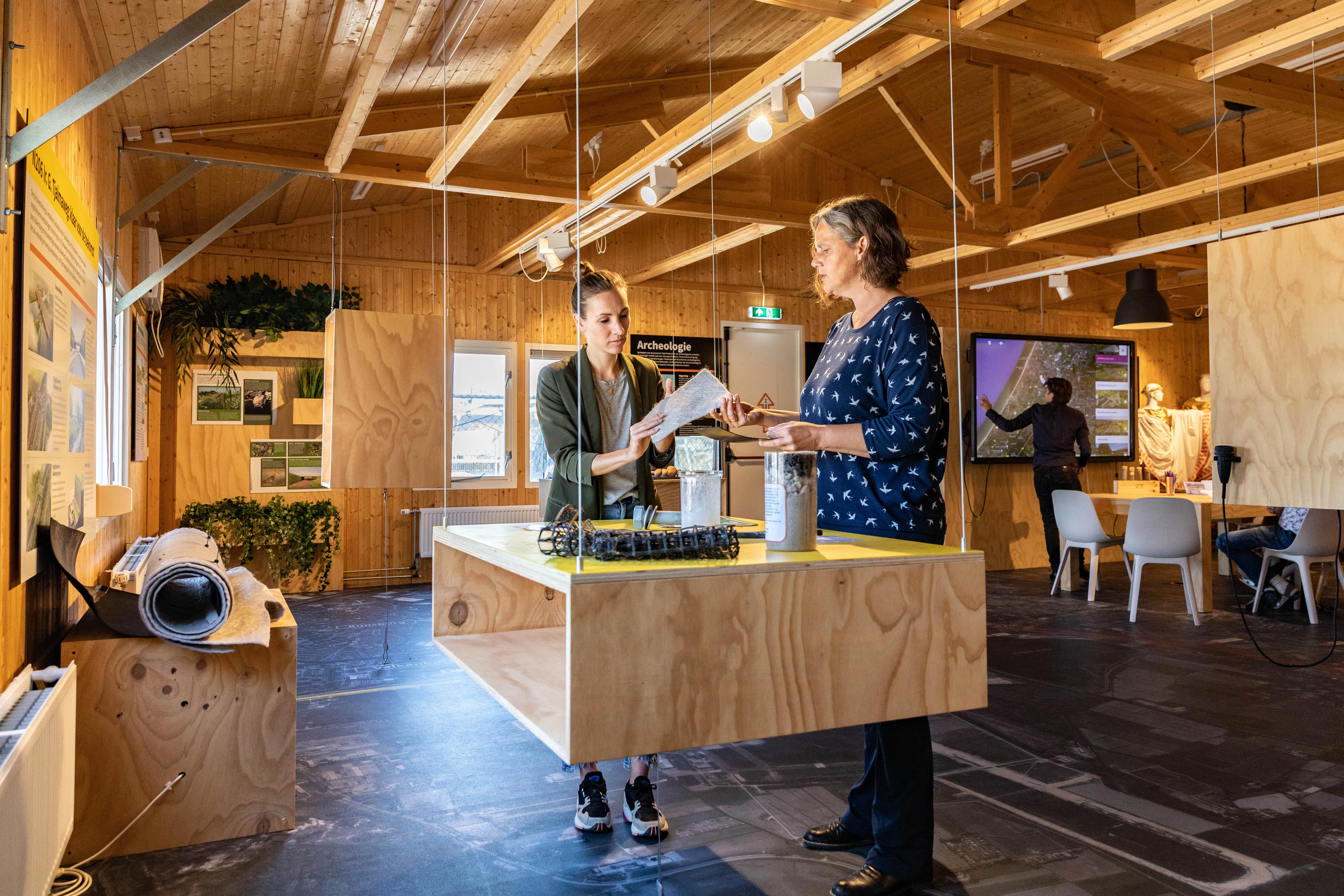 Bezoekers van infocentrum RijnlandRoute staan bij een exhibit